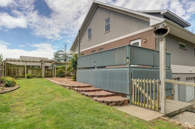 401 E Glendale St, Aurora, MO 65605 - view of property exterior with brick siding, a gate, and stucco siding
