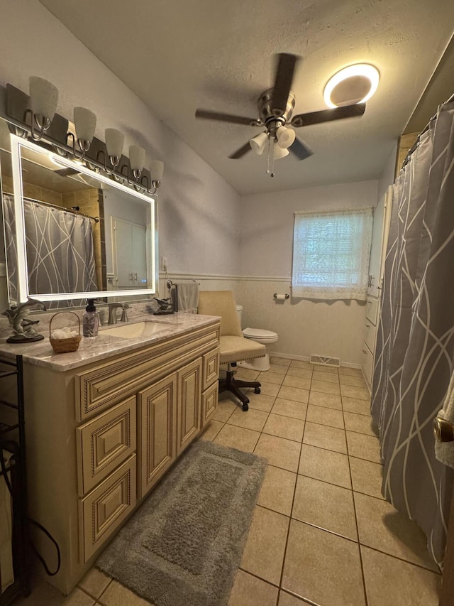 853 Sunset Ave, Marshfield, MO 65706 - full bath featuring tile patterned floors, vanity, toilet, ceiling fan, and a wainscoted wall