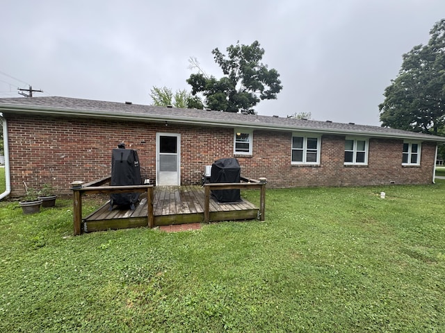 853 Sunset Ave, Marshfield, MO 65706 - back of house featuring a deck, brick siding, and a lawn