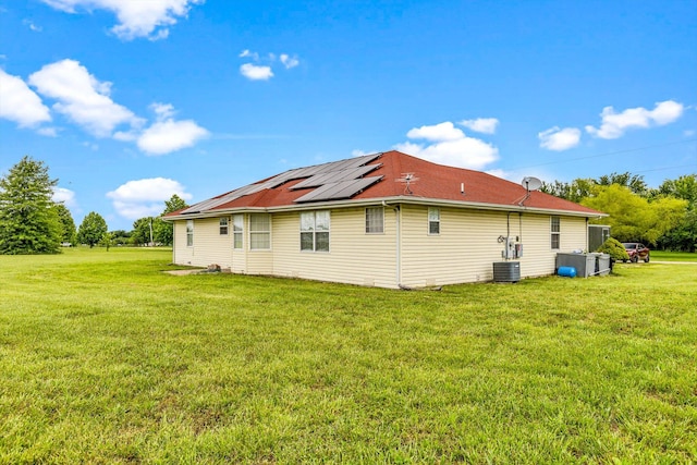 1640 E 541st Rd, Brighton, MO 65617 - view of home's exterior with roof mounted solar panels, a yard, and central air condition unit