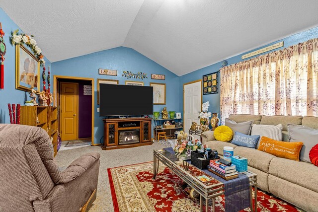 1640 E 541st Rd, Brighton, MO 65617 - carpeted living area with vaulted ceiling, a textured ceiling, and a glass covered fireplace