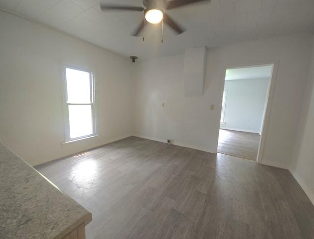 221 Boisseau St, Greenfield, MO 65661 - empty room featuring ceiling fan, wood finished floors, and baseboards
