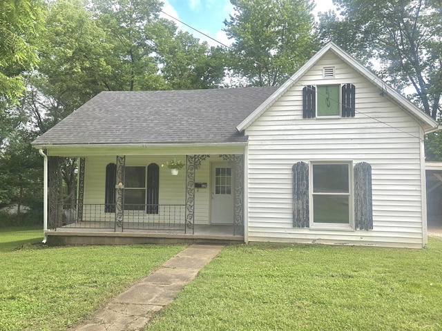 221 Boisseau St, Greenfield, MO 65661 - view of front of property featuring a porch, a front lawn, and roof with shingles