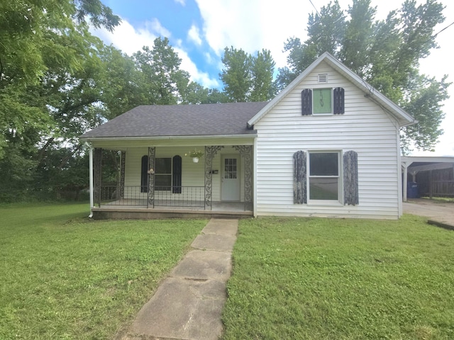 221 Boisseau St, Greenfield, MO 65661 - view of front of home featuring covered porch, a front lawn, and a shingled roof