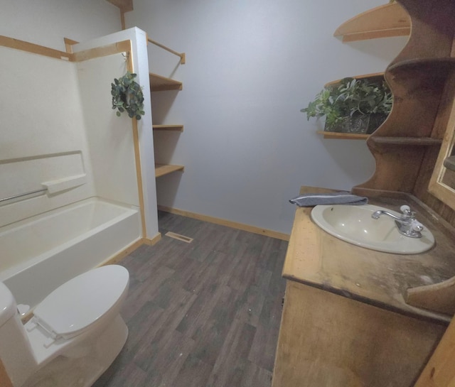 221 Boisseau St, Greenfield, MO 65661 - full bathroom with vanity, toilet, wood finished floors, baseboards, and shower / washtub combination