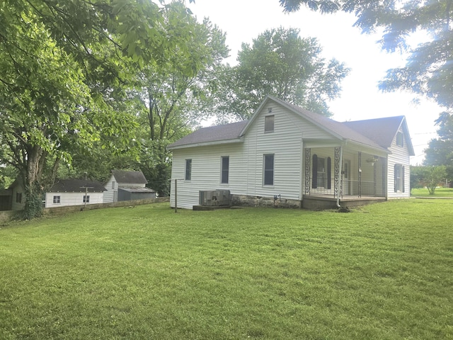 221 Boisseau St, Greenfield, MO 65661 - rear view of property featuring a porch, a lawn, and a shingled roof