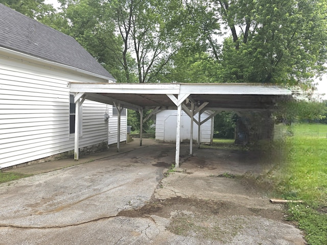 221 Boisseau St, Greenfield, MO 65661 - view of car parking featuring a storage shed, a detached carport, and driveway