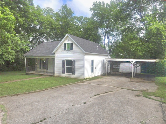 221 Boisseau St, Greenfield, MO 65661 - view of front of property with a carport, a front yard, driveway, a porch, and roof with shingles