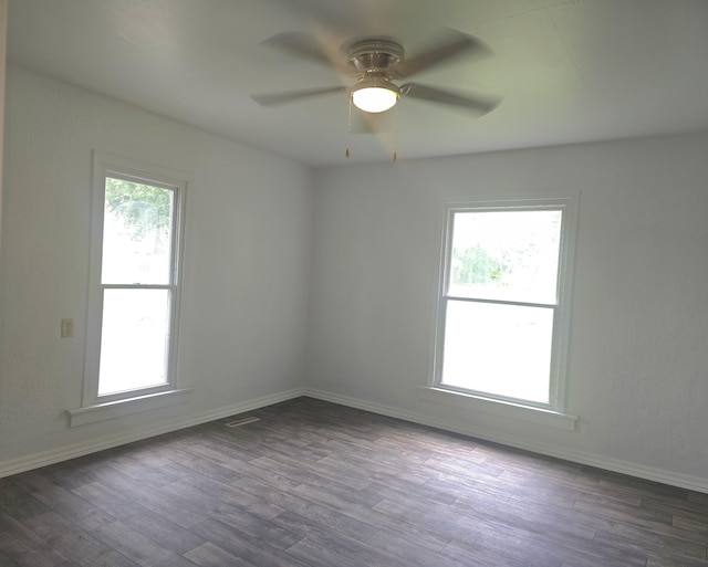221 Boisseau St, Greenfield, MO 65661 - empty room featuring dark wood-style flooring, ceiling fan, and baseboards