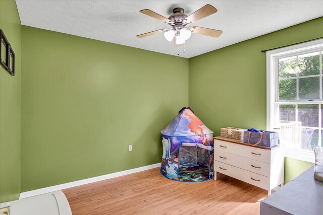 113 Holly Ridge Rd, Willard, MO 65781 - game room with light wood-style floors, a ceiling fan, and baseboards