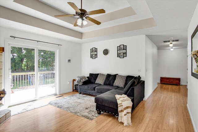 113 Holly Ridge Rd, Willard, MO 65781 - living area with light wood-style floors, a tray ceiling, a ceiling fan, and baseboards