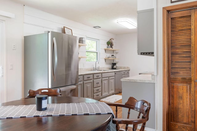 225 Elim St, Forsyth, MO 65653 - kitchen with stainless steel appliances, a sink, gray cabinetry, open shelves, and light countertops