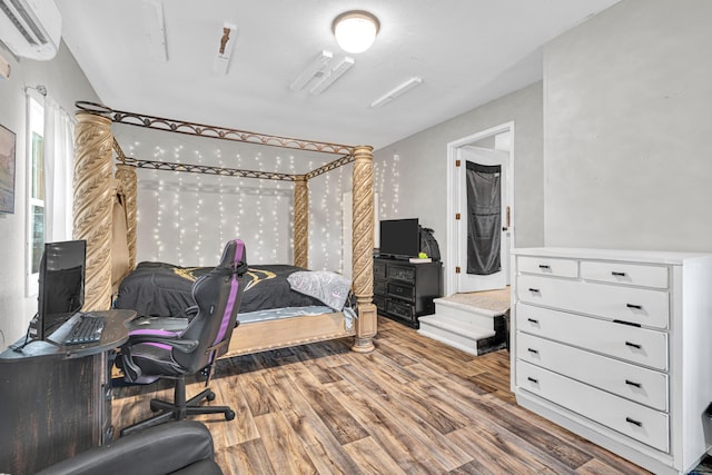 21371 Howell Rd, Mountain View, MO 65548 - bedroom featuring a wall mounted air conditioner and wood finished floors