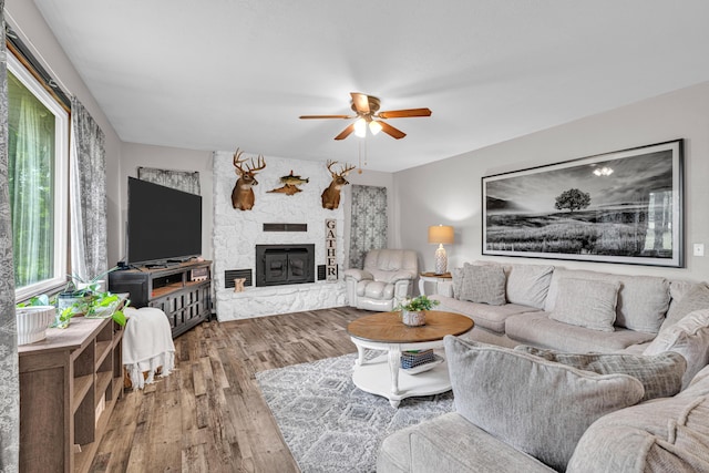 21371 Howell Rd, Mountain View, MO 65548 - living area with a ceiling fan, wood finished floors, and a stone fireplace