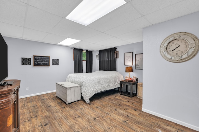 21371 Howell Rd, Mountain View, MO 65548 - bedroom featuring a drop ceiling, baseboards, and wood finished floors