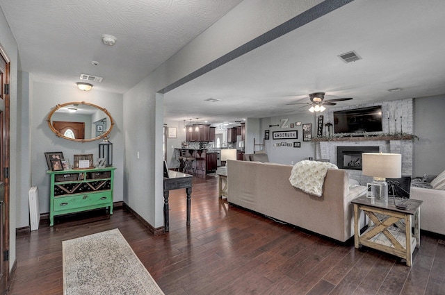 2526 State Highway B, Rogersville, MO 65742 - living area with dark wood-style flooring, ceiling fan, and a fireplace