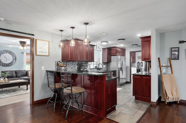 2526 State Highway B, Rogersville, MO 65742 - kitchen with dark brown cabinets, stainless steel fridge, a peninsula, and baseboards