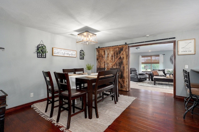 2526 State Highway B, Rogersville, MO 65742 - dining space featuring a barn door, wood finished floors, baseboards, and a chandelier