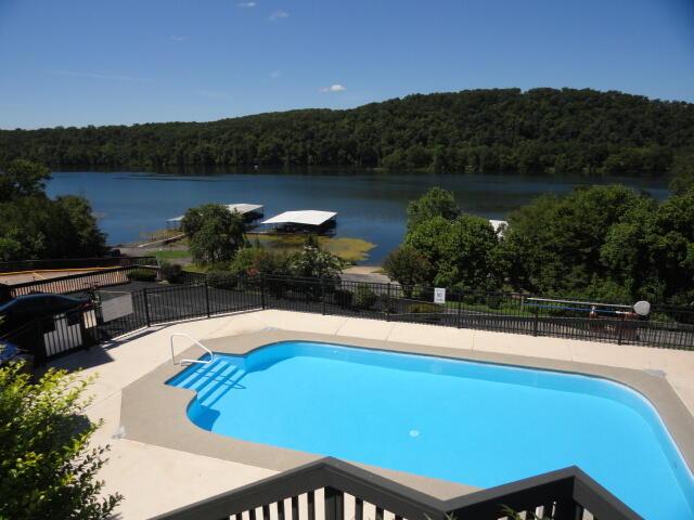 154A Scofield Ave, Forsyth, MO 65653 - view of swimming pool with a view of trees, a water view, and a patio area