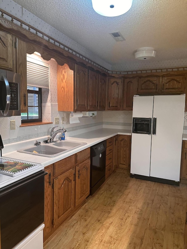 154A Scofield Ave, Forsyth, MO 65653 - kitchen with white fridge with ice dispenser, range with electric cooktop, dishwasher, stainless steel microwave, and light wood finished floors