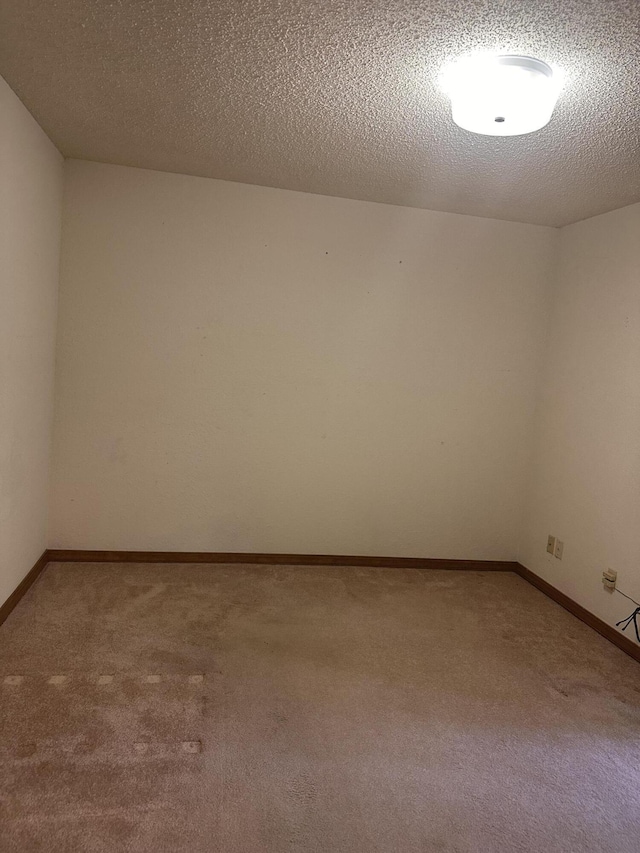 154A Scofield Ave, Forsyth, MO 65653 - unfurnished room with carpet, a textured ceiling, and baseboards