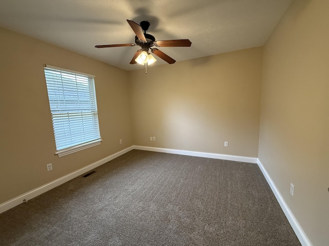 895 W Linwood Ave, Nixa, MO 65714 - spare room featuring a ceiling fan, dark carpet, and baseboards
