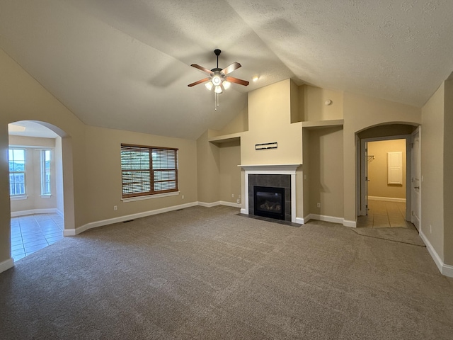 895 W Linwood Ave, Nixa, MO 65714 - unfurnished living room featuring arched walkways, carpet, ceiling fan, vaulted ceiling, and a fireplace