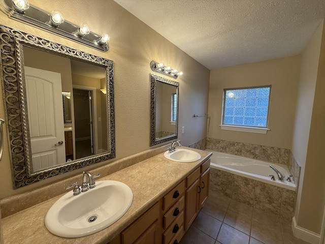 895 W Linwood Ave, Nixa, MO 65714 - bathroom featuring tile patterned flooring, a textured ceiling, a bath, and double vanity