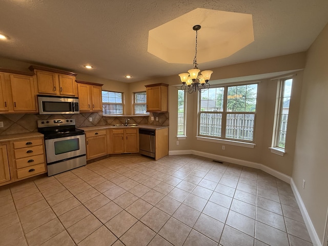 895 W Linwood Ave, Nixa, MO 65714 - kitchen featuring stainless steel appliances, a sink, decorative backsplash, a chandelier, and light tile patterned flooring