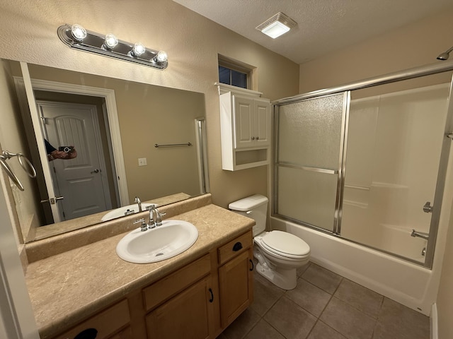 895 W Linwood Ave, Nixa, MO 65714 - bathroom featuring a textured ceiling, vanity, tile patterned floors, toilet, and enclosed tub / shower combo