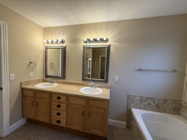 895 W Linwood Ave, Nixa, MO 65714 - full bath featuring a textured ceiling, double vanity, tile patterned flooring, a relaxing tiled tub, and baseboards