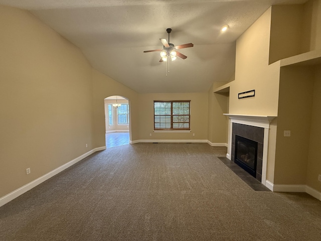 895 W Linwood Ave, Nixa, MO 65714 - unfurnished living room featuring dark carpet, a ceiling fan, a tile fireplace, baseboards, and lofted ceiling