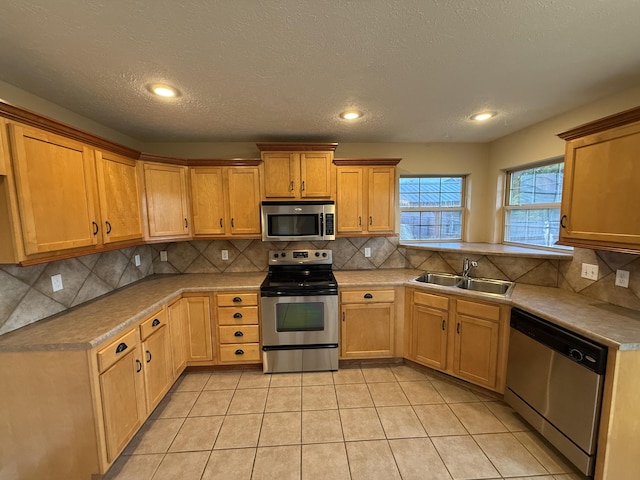 895 W Linwood Ave, Nixa, MO 65714 - kitchen featuring appliances with stainless steel finishes, a sink, tasteful backsplash, light tile patterned flooring, and recessed lighting