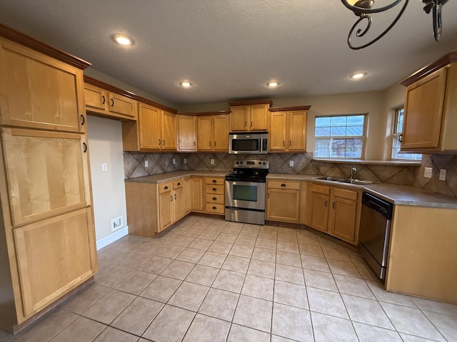 895 W Linwood Ave, Nixa, MO 65714 - kitchen with appliances with stainless steel finishes, a sink, decorative backsplash, light tile patterned floors, and recessed lighting