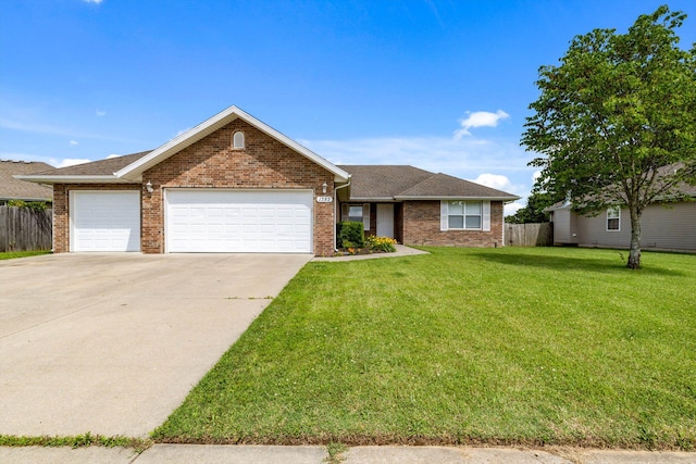 1382 S Kristopher Ave, Republic, MO 65738 - view of front of property featuring a garage, brick siding, and driveway