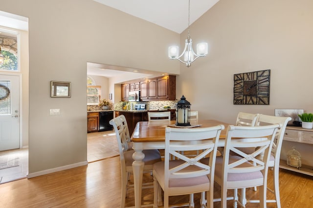 1749 Cedar Ridge Way, Branson West, MO 65737 - dining area featuring high vaulted ceiling, a chandelier, light wood-type flooring, and healthy amount of natural light