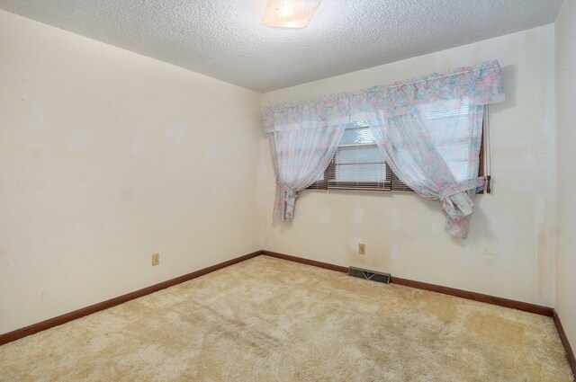 510 E College St, Walnut Grove, MO 65770 - empty room featuring carpet floors, a textured ceiling, and baseboards