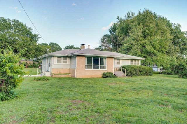 510 E College St, Walnut Grove, MO 65770 - view of front of home featuring a chimney, brick siding, and a front lawn