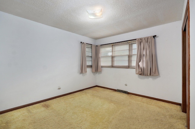 510 E College St, Walnut Grove, MO 65770 - unfurnished room with carpet flooring, baseboards, and a textured ceiling