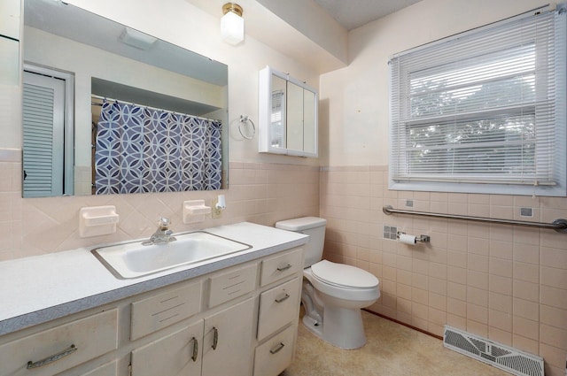 510 E College St, Walnut Grove, MO 65770 - full bath featuring toilet, vanity, tile walls, and a wainscoted wall