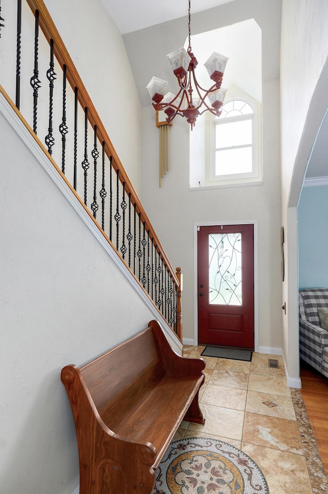 4402 Quail Run Rd, Ozark, MO 65721 - foyer with a chandelier, high vaulted ceiling, arched walkways, stairs, and baseboards