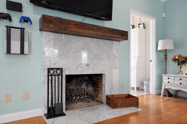 4402 Quail Run Rd, Ozark, MO 65721 - detailed view of baseboards, a fireplace, and wood finished floors