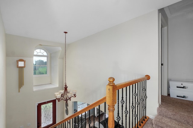 4402 Quail Run Rd, Ozark, MO 65721 - corridor featuring a chandelier, carpet floors, and an upstairs landing