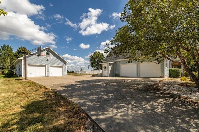 4402 Quail Run Rd, Ozark, MO 65721 - view of home's exterior featuring an outbuilding, a detached garage, and a yard