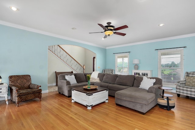 4402 Quail Run Rd, Ozark, MO 65721 - living room with wood finished floors, crown molding, a ceiling fan, arched walkways, and stairs