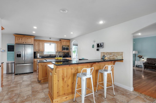 4402 Quail Run Rd, Ozark, MO 65721 - kitchen featuring stainless steel appliances, a sink, tasteful backsplash, a peninsula, and a kitchen breakfast bar