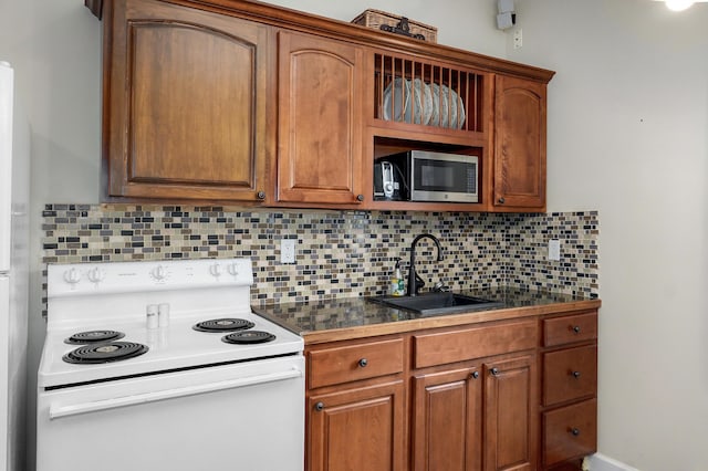 4402 Quail Run Rd, Ozark, MO 65721 - kitchen featuring white electric range oven, stainless steel microwave, a sink, dark countertops, and decorative backsplash