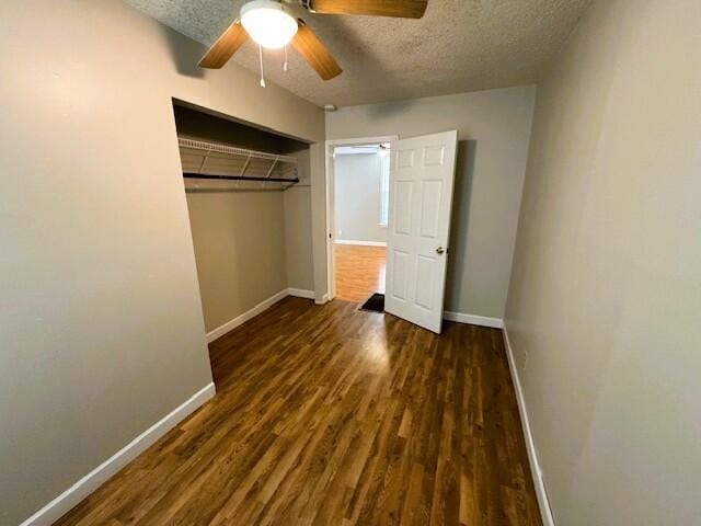1211 W Calhoun St, Springfield, MO 65802 - unfurnished bedroom featuring a textured ceiling, baseboards, wood finished floors, a closet, and ceiling fan