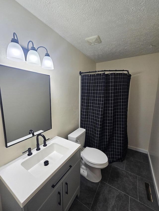 2460 S National Ave, Springfield, MO 65804 - bathroom with tiled shower, vanity, toilet, tile patterned floors, and a textured ceiling