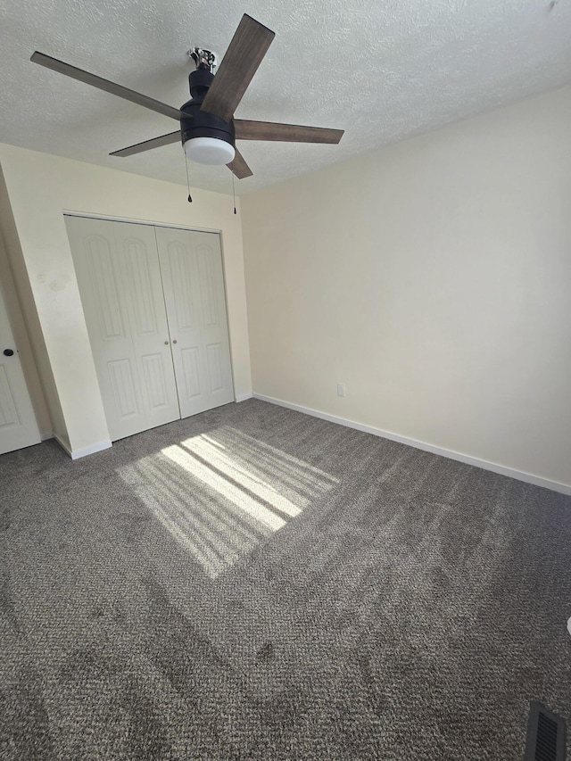 2460 S National Ave, Springfield, MO 65804 - unfurnished bedroom featuring a textured ceiling, a closet, carpet flooring, a ceiling fan, and baseboards
